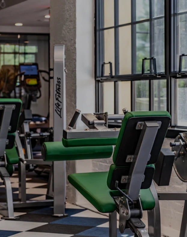Three friends laugh around a grill on a summer afternoon