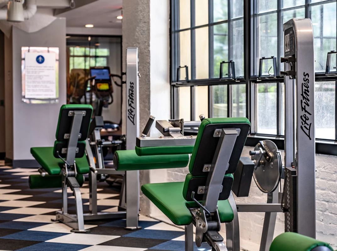 Three friends laugh around a grill on a summer afternoon