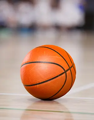 Three friends laugh around a grill on a summer afternoon