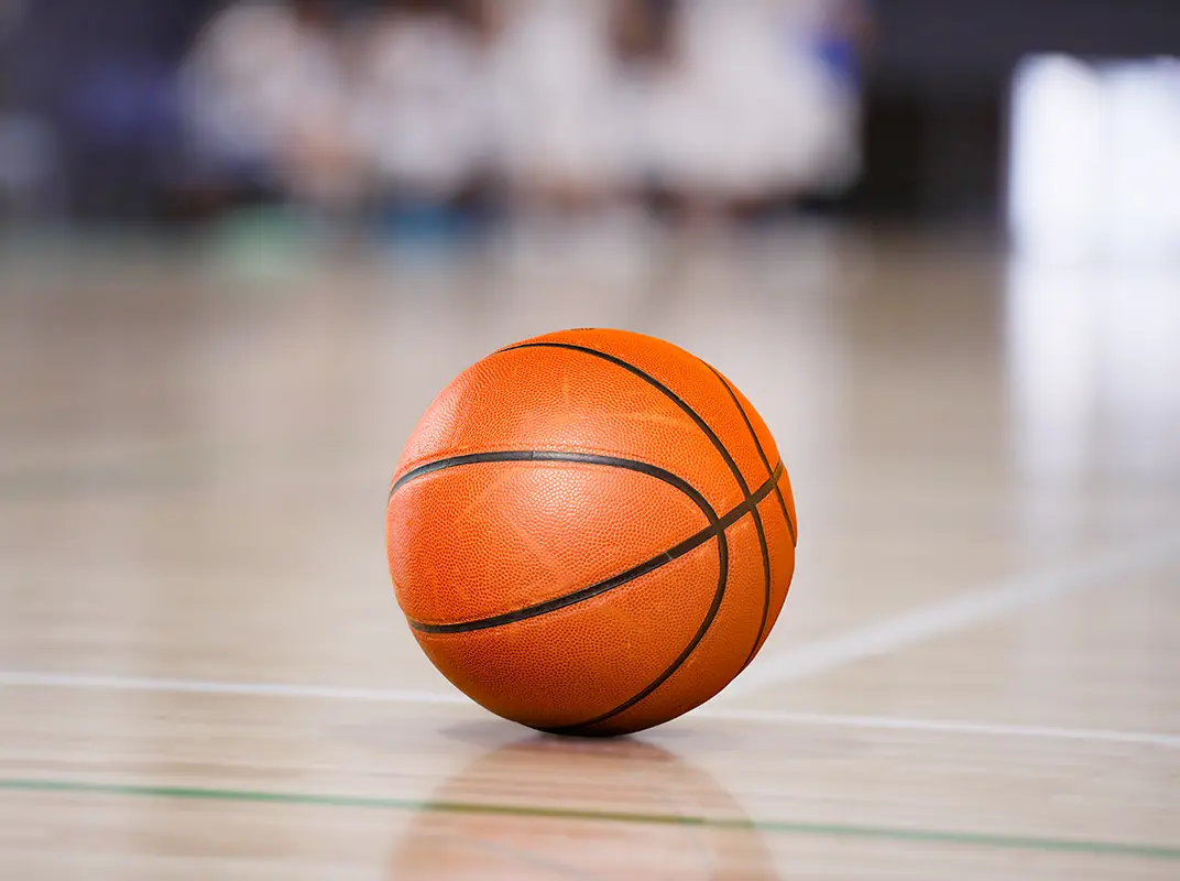 Three friends laugh around a grill on a summer afternoon