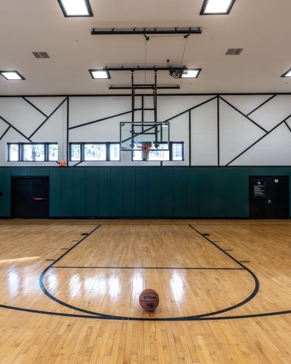Three friends laugh around a grill on a summer afternoon