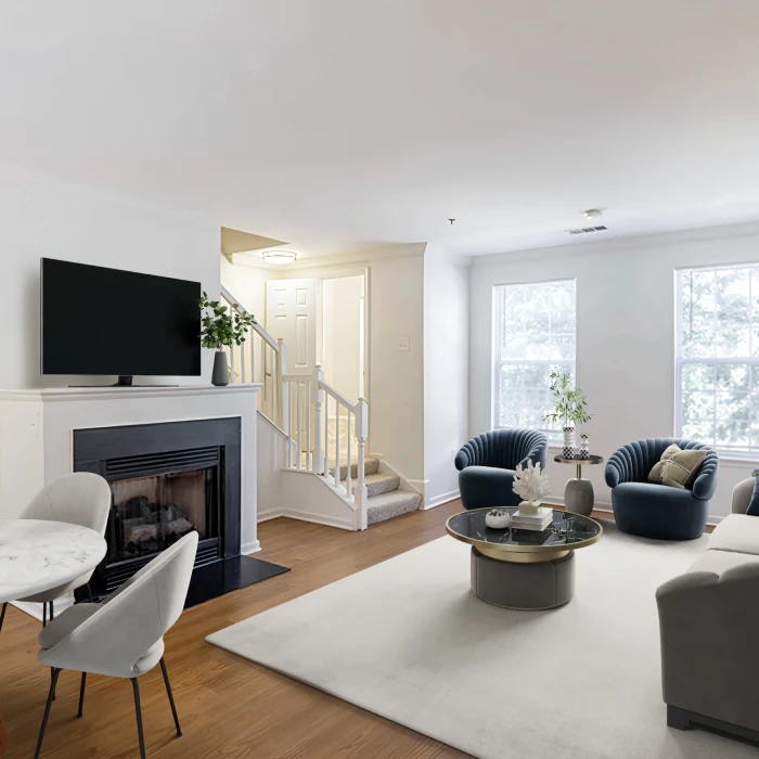 Stylish furnished apartment living room featuring modern seating, flat-screen television, and cozy fireplace